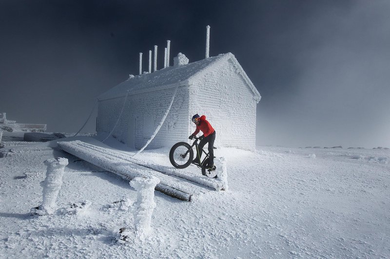 Tim Johnson climbs Mount Washington on his fat bike for the first winter ascent of the auto road on a bicycle on Mount Washington in Gorham, NH on February 2, 2016. (Brian Nevins/Red Bull Photo)