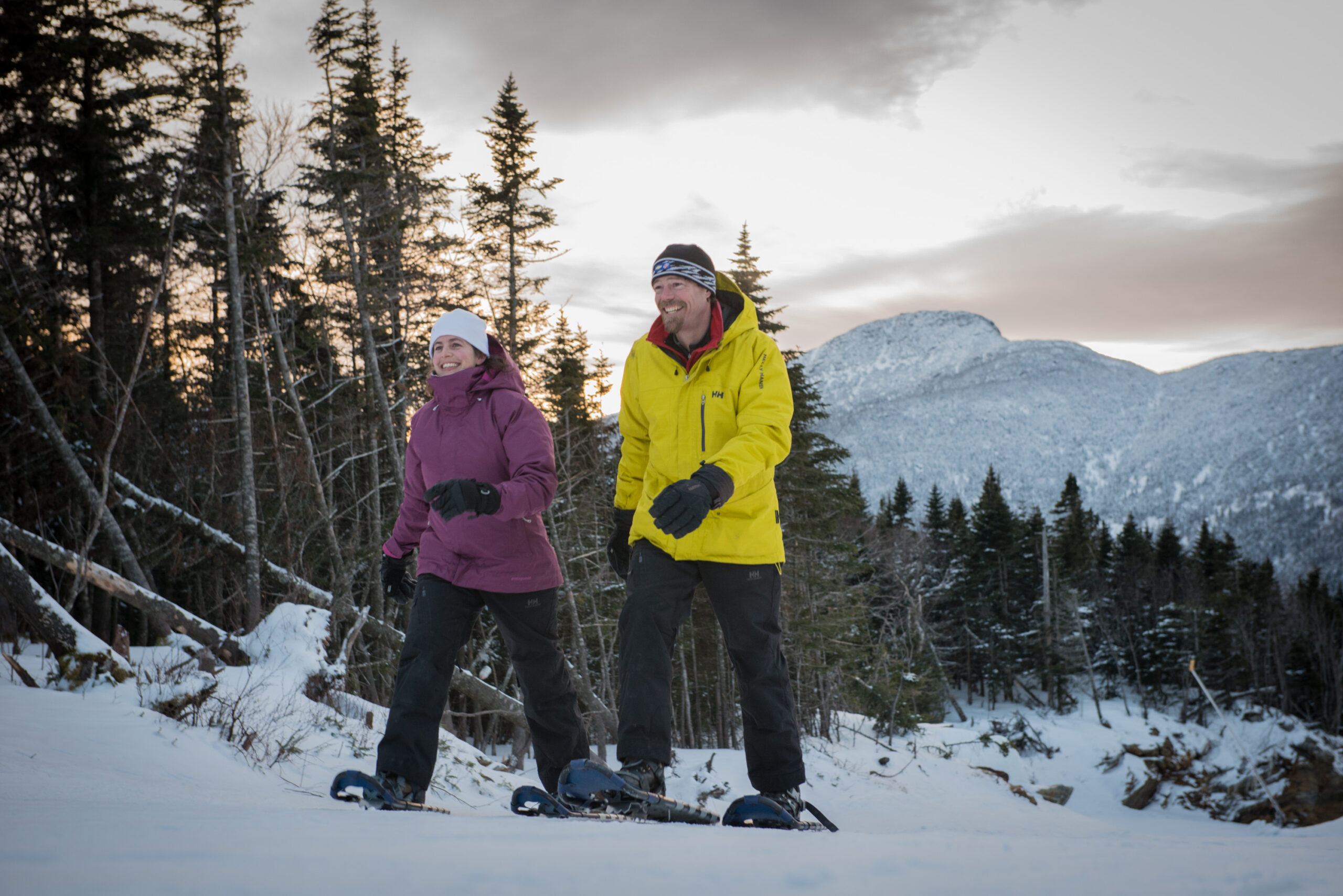 Two snowshoers snowshoeing on a mountain in Vermont.